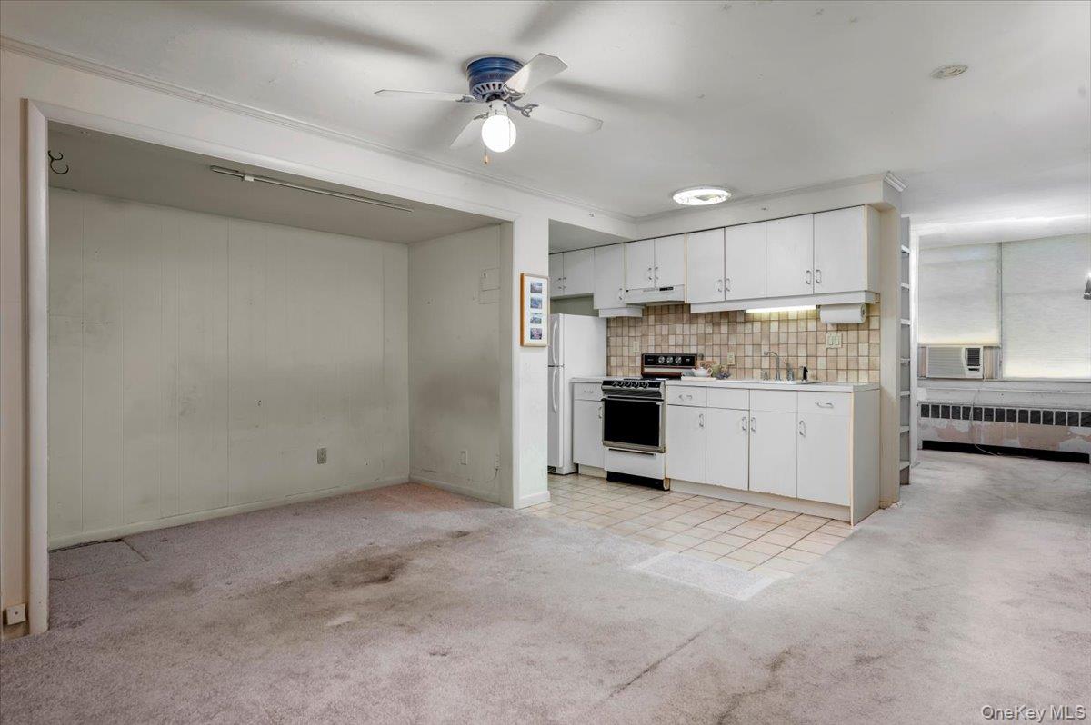 580 Bedford Road, Unit 8 Pleasantville, NY 10570 - Photo 9 of 35 a view of a kitchen with a sink and dishwasher a refrigerator with white cabinets