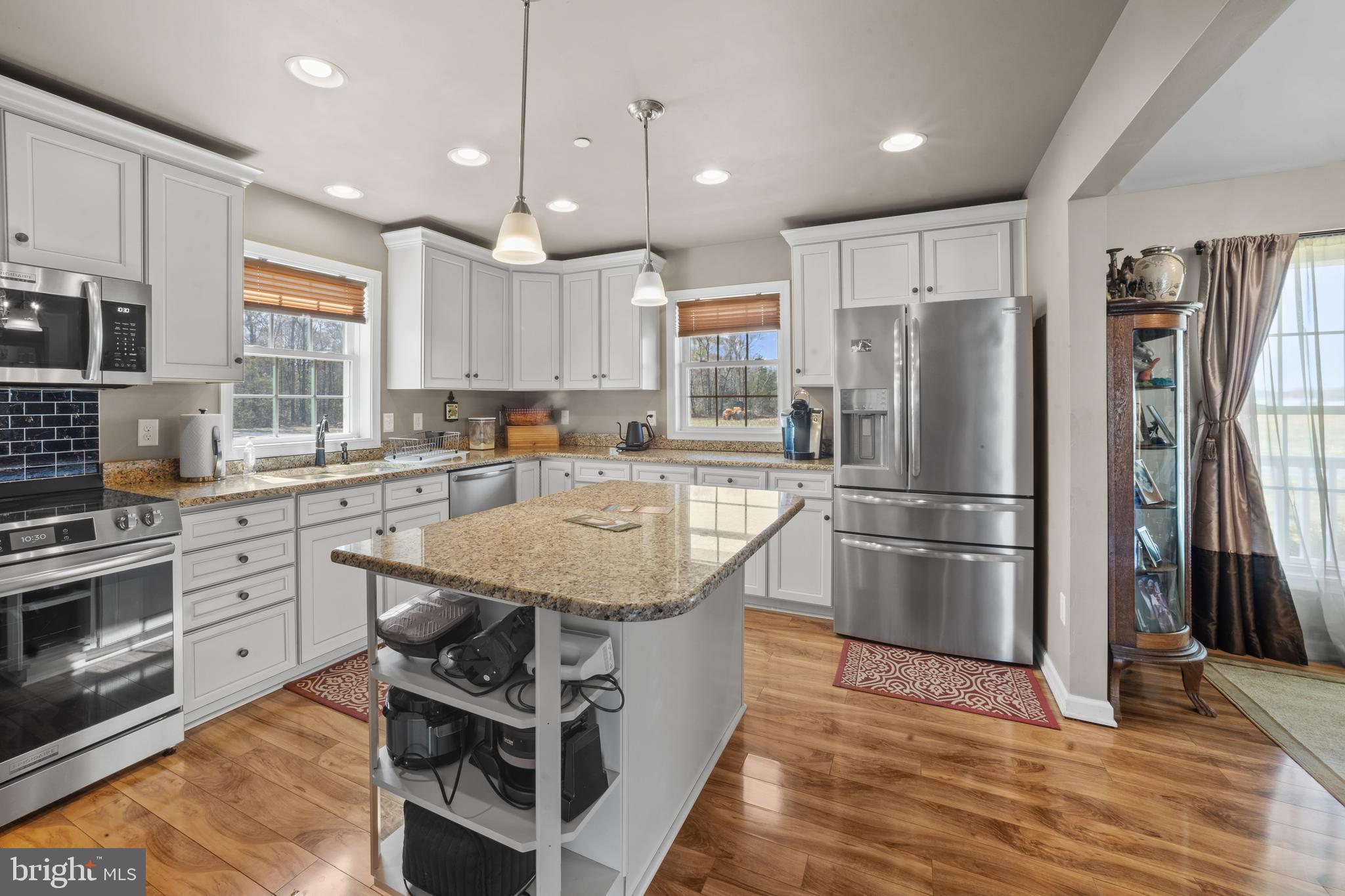 26268 Baker Road Denton, MD 21629 - Photo 14 of 55 a kitchen with stainless steel appliances granite countertop a sink stove and refrigerator