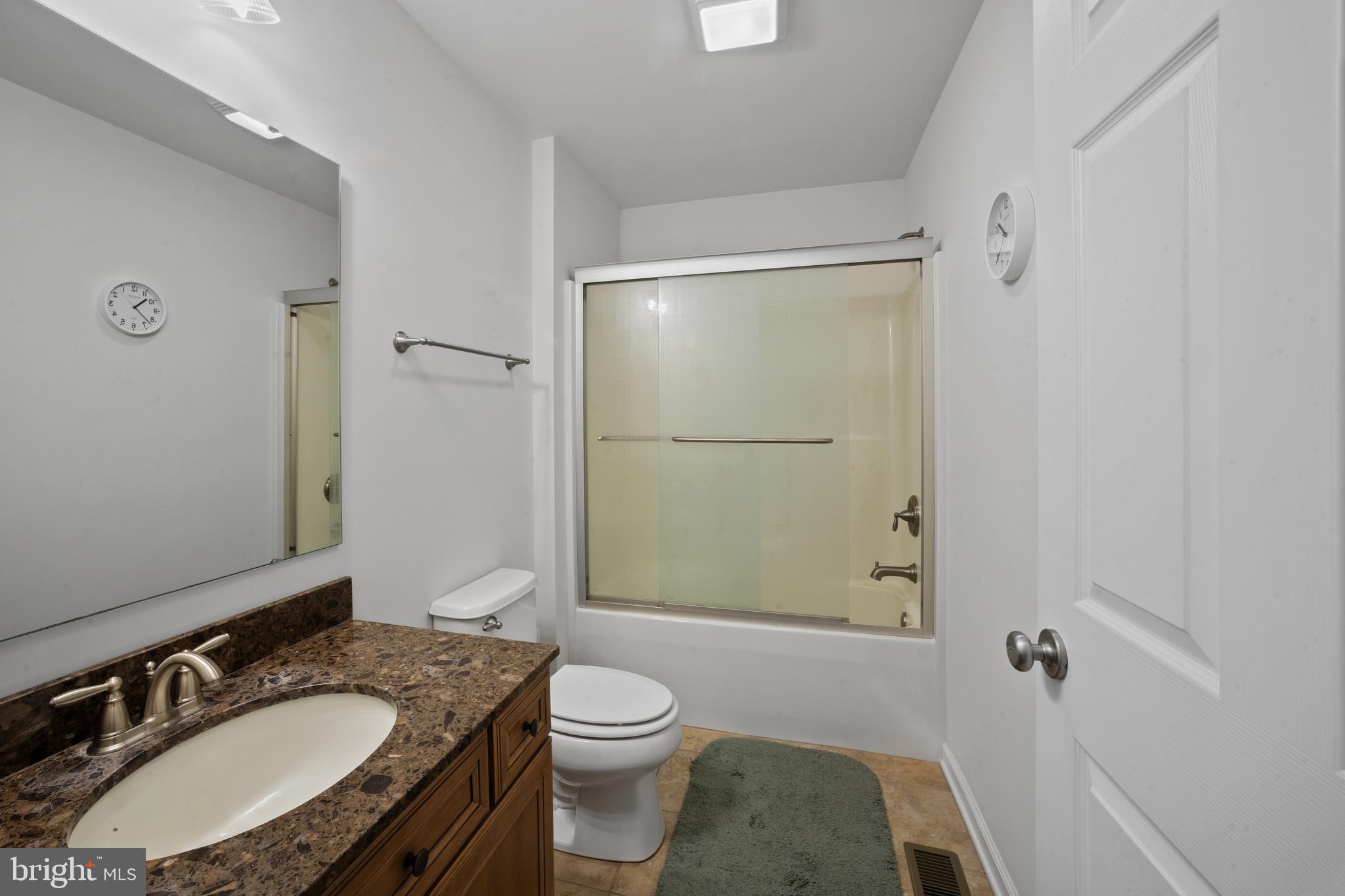26268 Baker Road Denton, MD 21629 - Photo 20 of 55 a bathroom with a sink a toilet a mirror and shower
