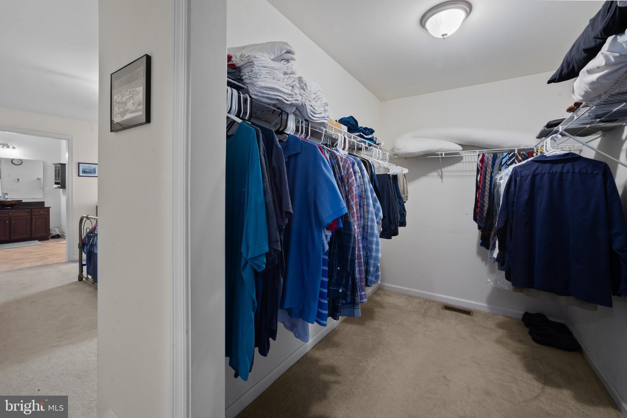 26268 Baker Road Denton, MD 21629 - Photo 26 of 55 a view of walk in closet with clothes and shoes