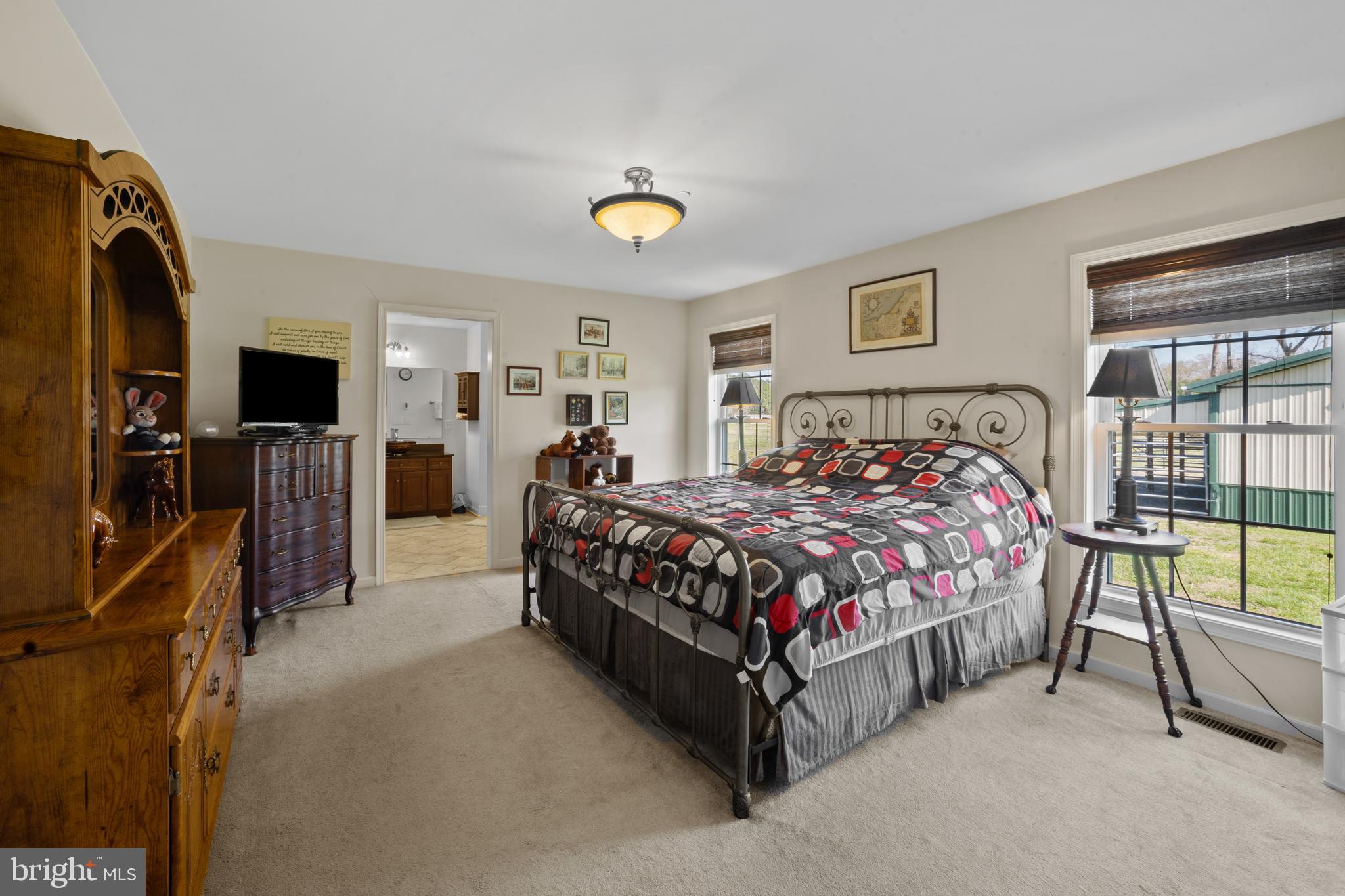 26268 Baker Road Denton, MD 21629 - Photo 6 of 55 a bedroom with a bed and a flat tv screen on dresser