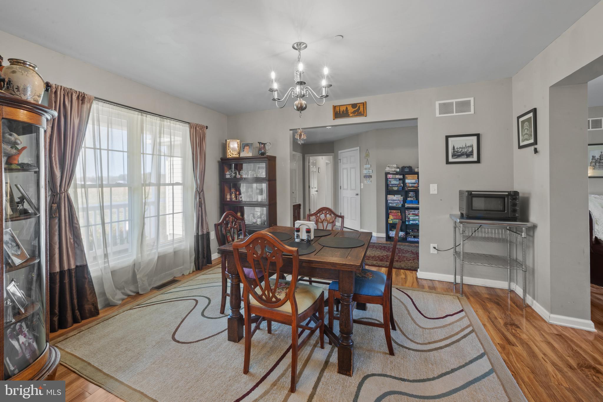 26268 Baker Road Denton, MD 21629 - Photo 10 of 55 a view of a dining room with furniture window and wooden floor