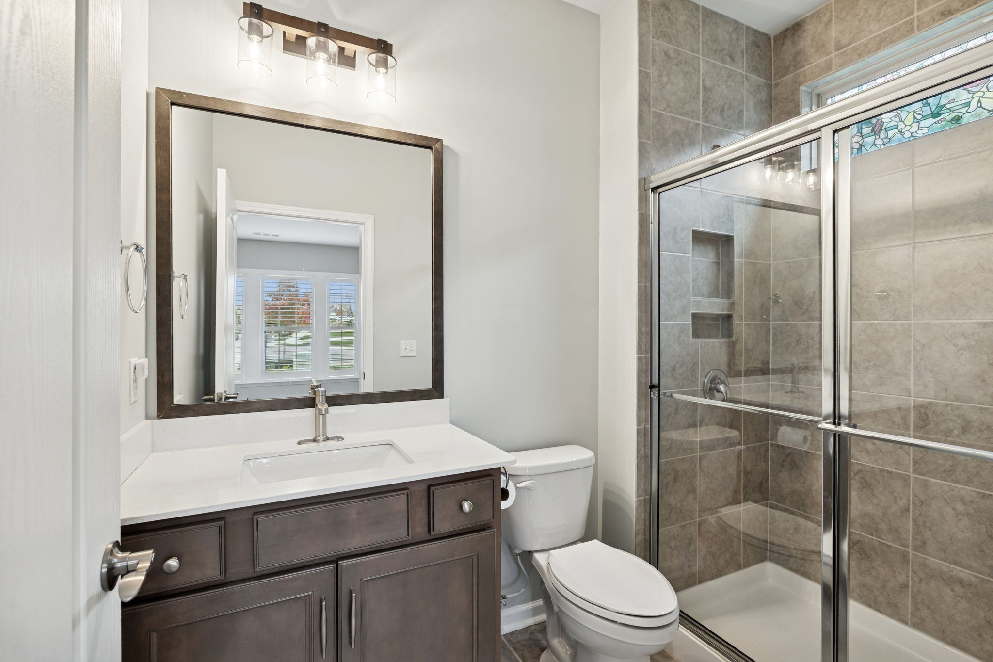 7027 Hickman Way Spring Hill, TN 37174 - Photo 12 of 61 a bathroom with a sink toilet and shower
