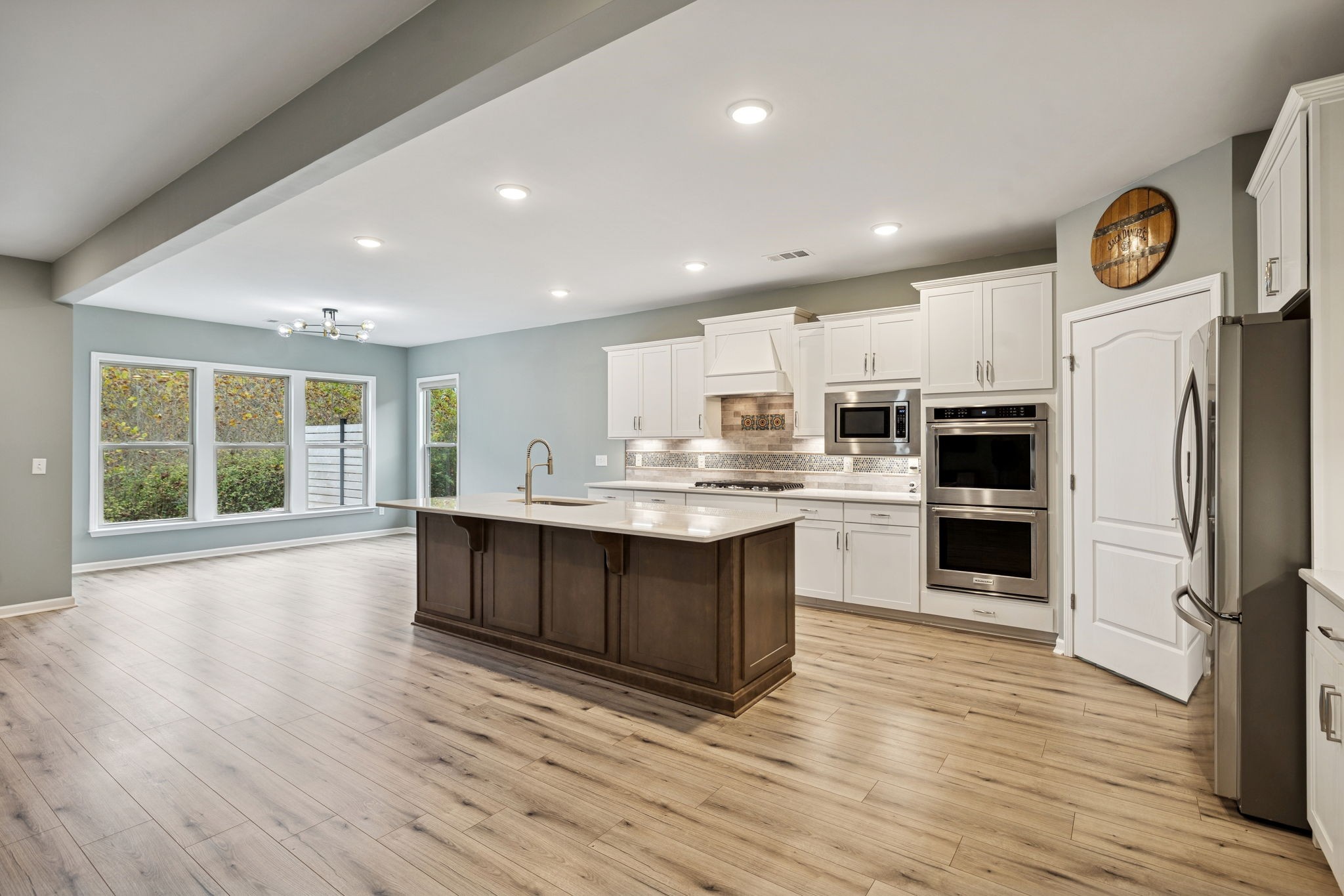 7027 Hickman Way Spring Hill, TN 37174 - Photo 14 of 61 a kitchen with stainless steel appliances granite countertop a stove top oven a refrigerator a sink and a oven with wooden floors