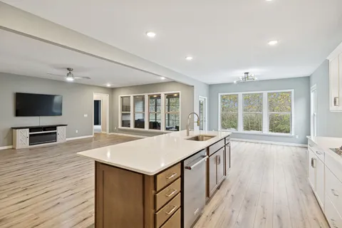a dining room with furniture a chandelier and wooden floor