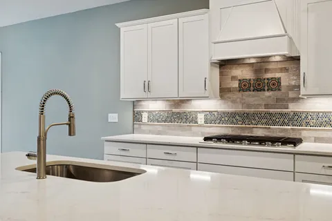 a view of a kitchen with a sink and a refrigerator