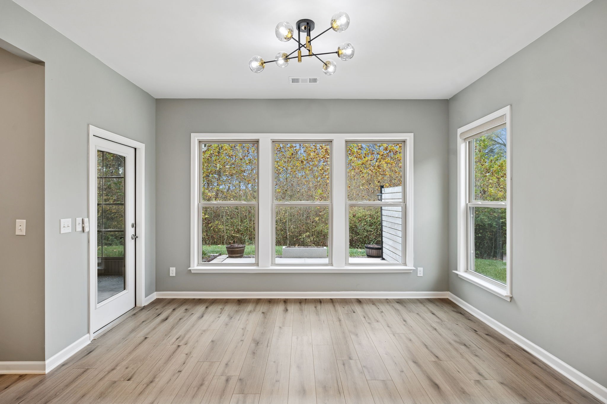 7027 Hickman Way Spring Hill, TN 37174 - Photo 20 of 61 a view of an empty room with wooden floor and a window