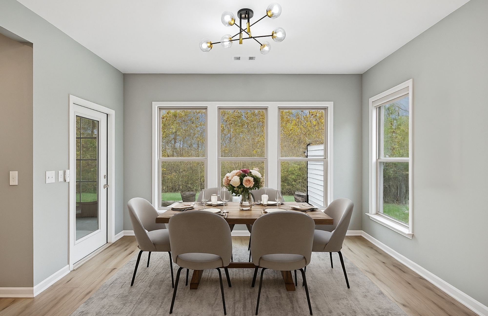 7027 Hickman Way Spring Hill, TN 37174 - Photo 21 of 61 a dining room with furniture a chandelier and wooden floor