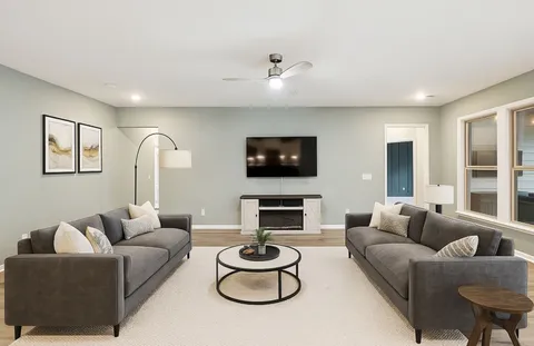 a view of an empty room with a ceiling fan