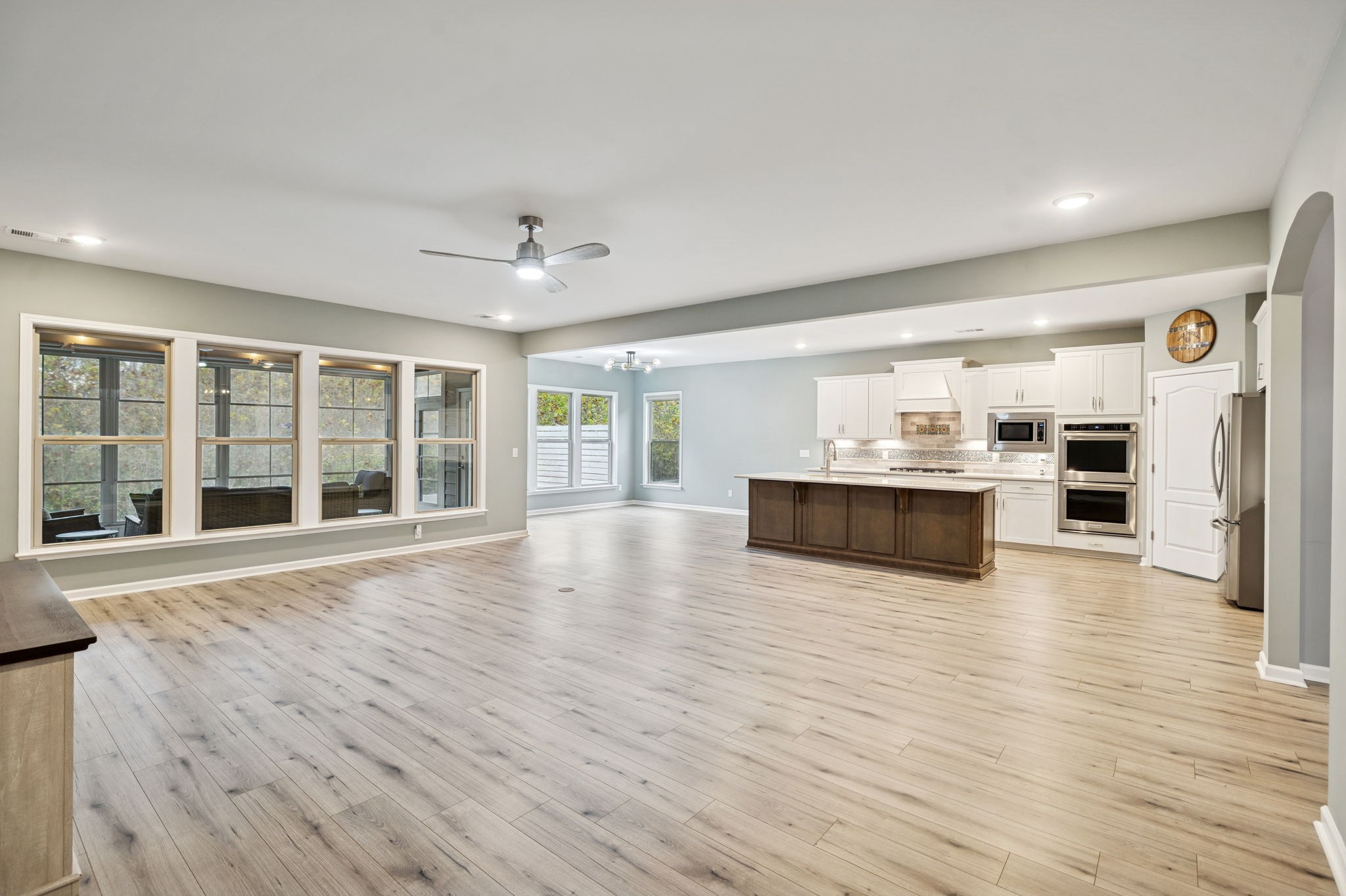 7027 Hickman Way Spring Hill, TN 37174 - Photo 25 of 61 a large white kitchen with wooden floors and a fireplace