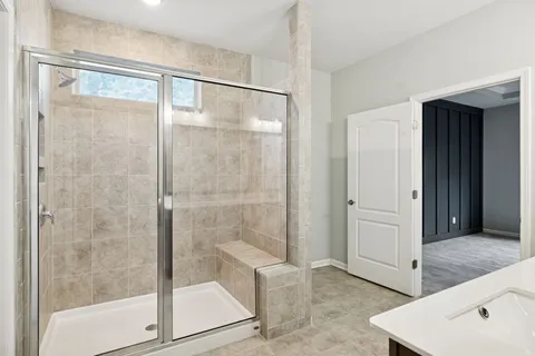 a bathroom with a granite countertop sink toilet a mirror and shower