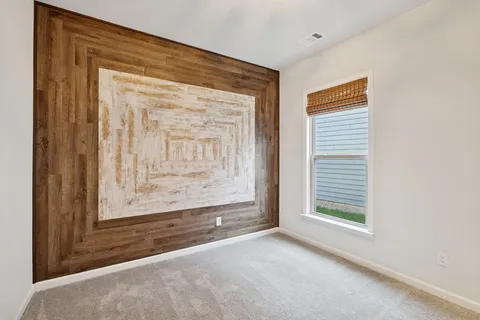a living room with furniture a flat screen tv and a floor to ceiling window