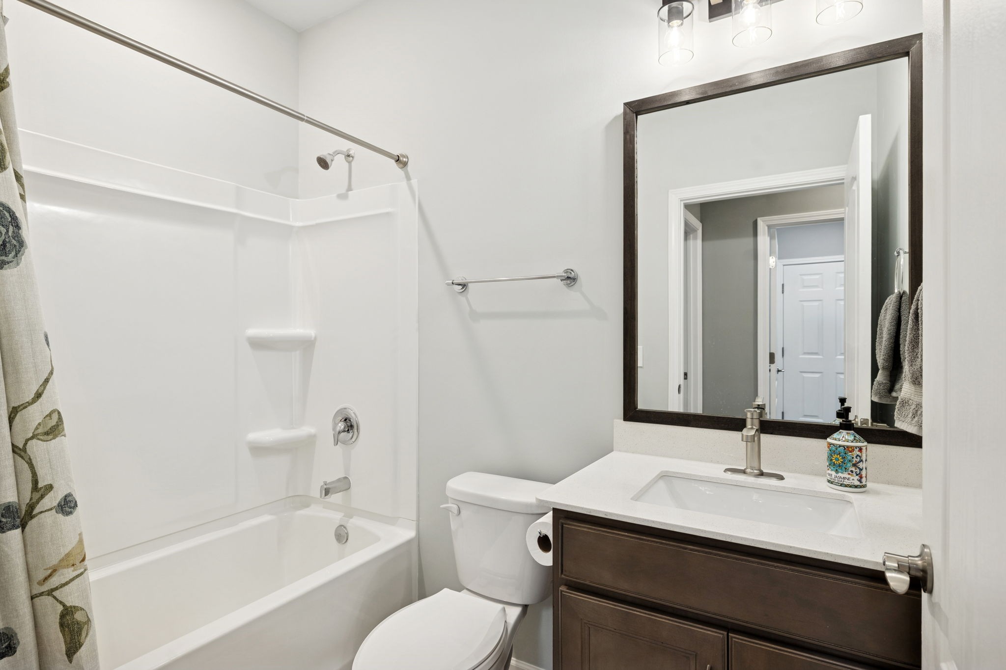7027 Hickman Way Spring Hill, TN 37174 - Photo 38 of 61 a bathroom with a granite countertop sink toilet a mirror and shower