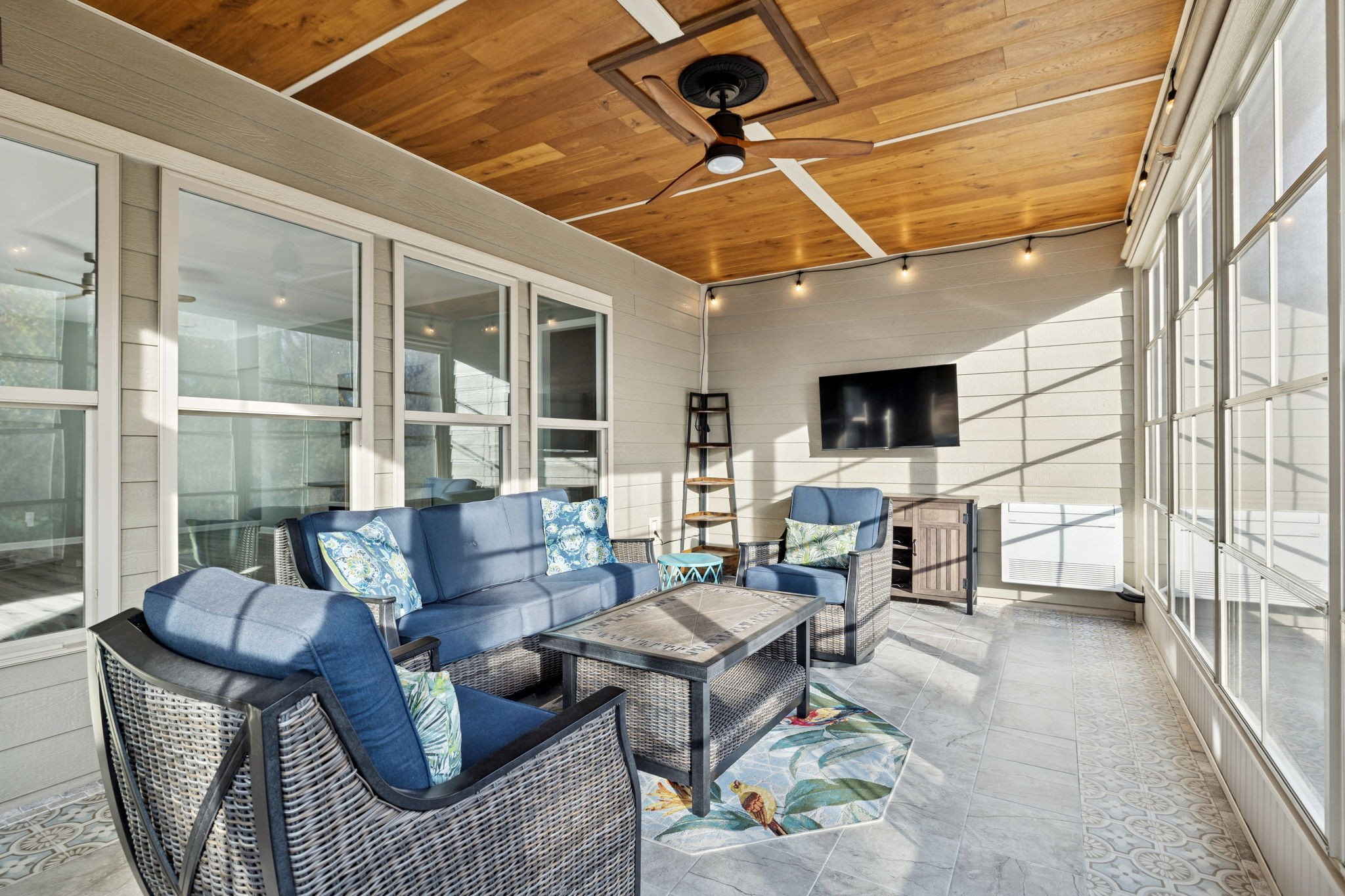 7027 Hickman Way Spring Hill, TN 37174 - Photo 43 of 61 a living room with furniture a flat screen tv and a floor to ceiling window