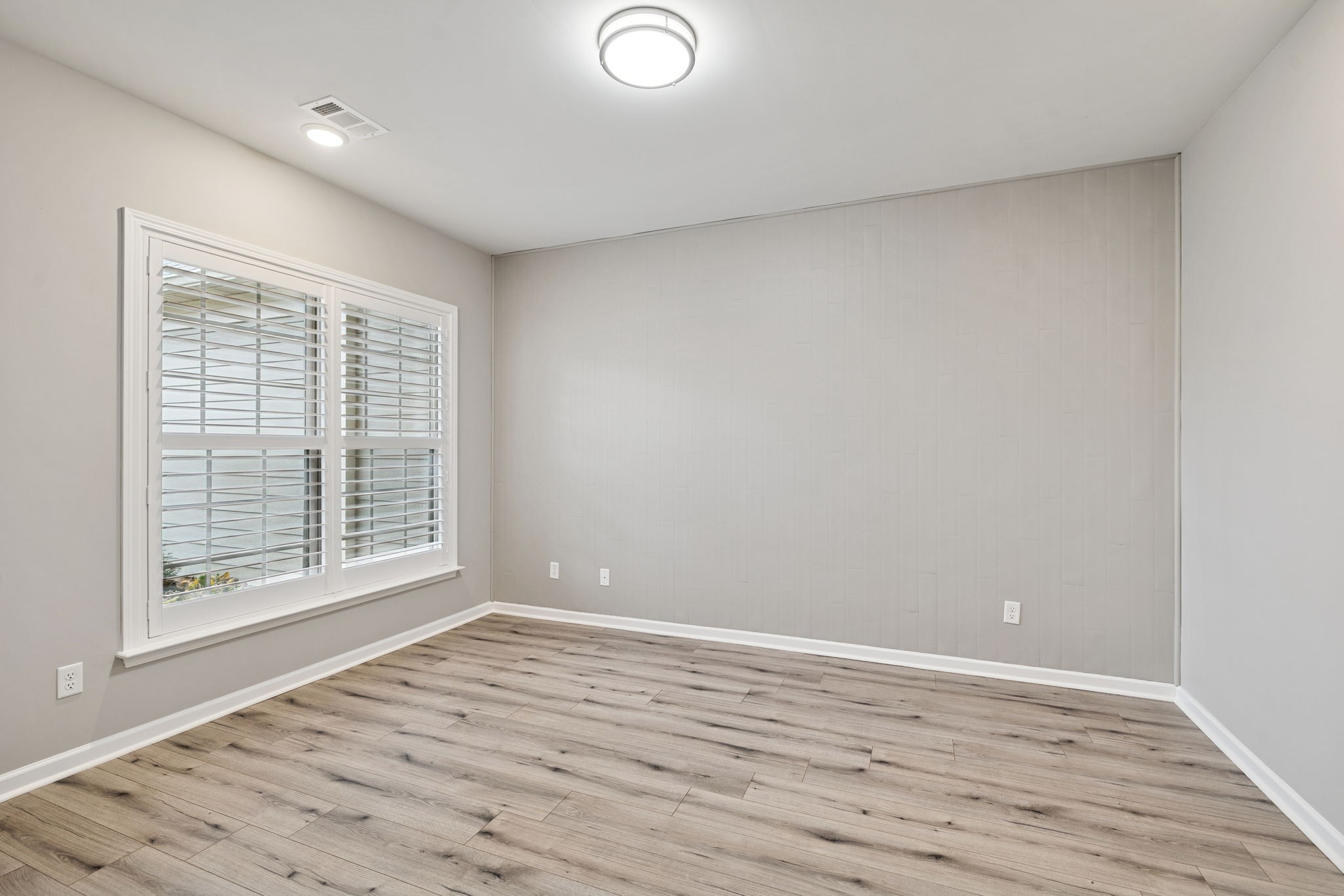 7027 Hickman Way Spring Hill, TN 37174 - Photo 8 of 61 a view of an empty room with wooden floor and a window