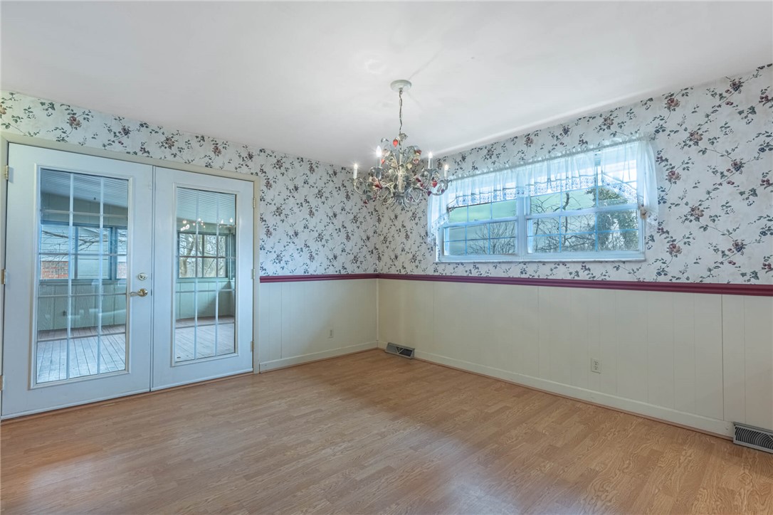 6300 Carnation Road Dayton, OH 45449 - Photo 11 of 35 This bright room features a classic chandelier and French doors, creating an inviting atmosphere.