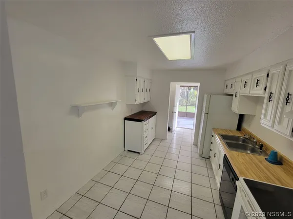 a room with a washing machine and cabinets