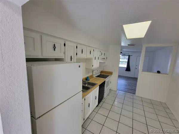 a kitchen with stainless steel appliances a refrigerator sink and cabinets