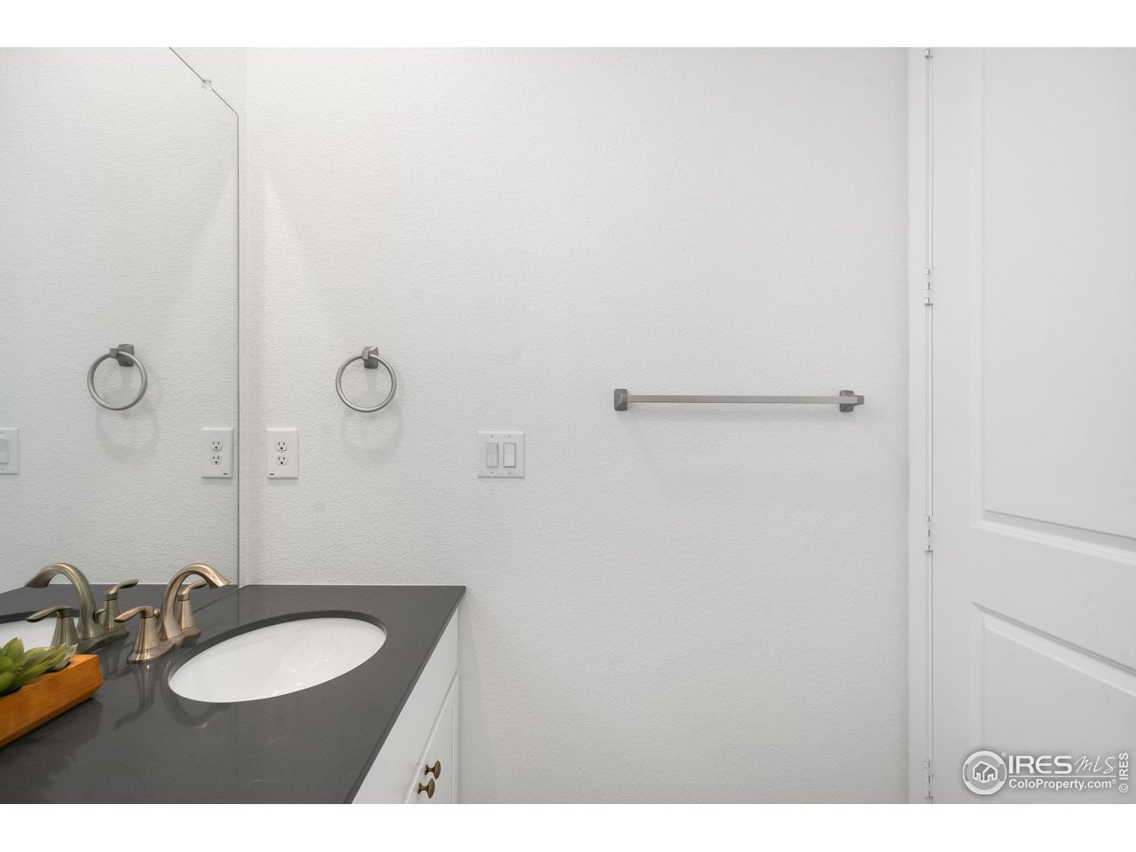 840 Clover Loop Lafayette, CO 80026 - Photo 30 of 39 a bathroom with a sink vanity mirror and toilet