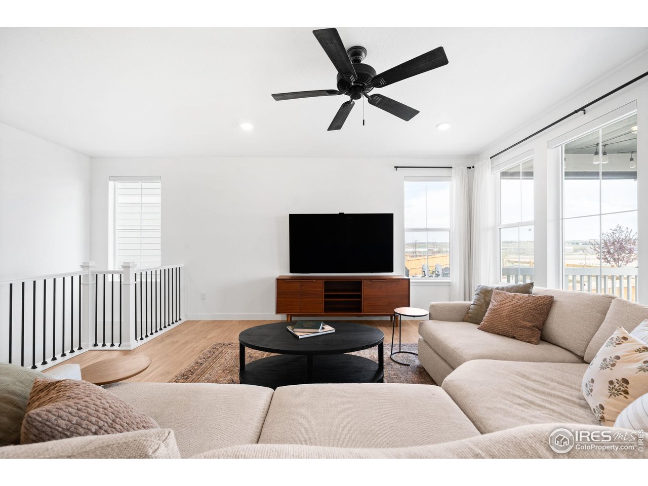 840 Clover Loop Lafayette, CO 80026 - Photo 6 of 39 a living room with furniture and a flat screen tv