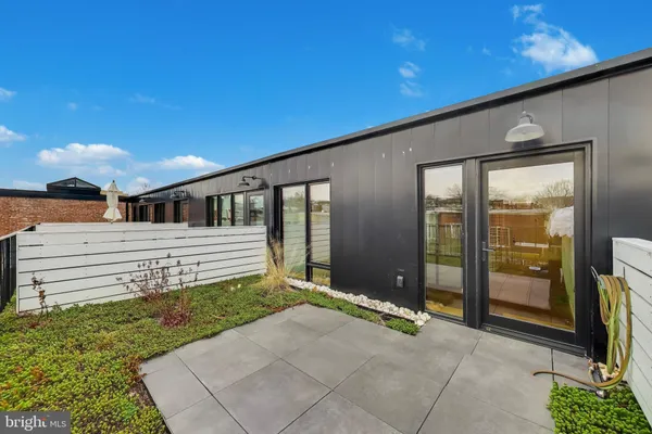 a porch with a table and chairs