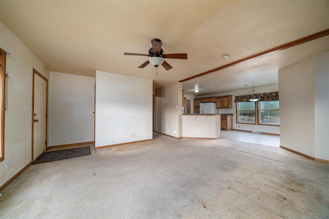 2202 H Road Grand Junction, CO 81505 - Photo 3 of 23 a view of a livingroom with a ceiling fan and window