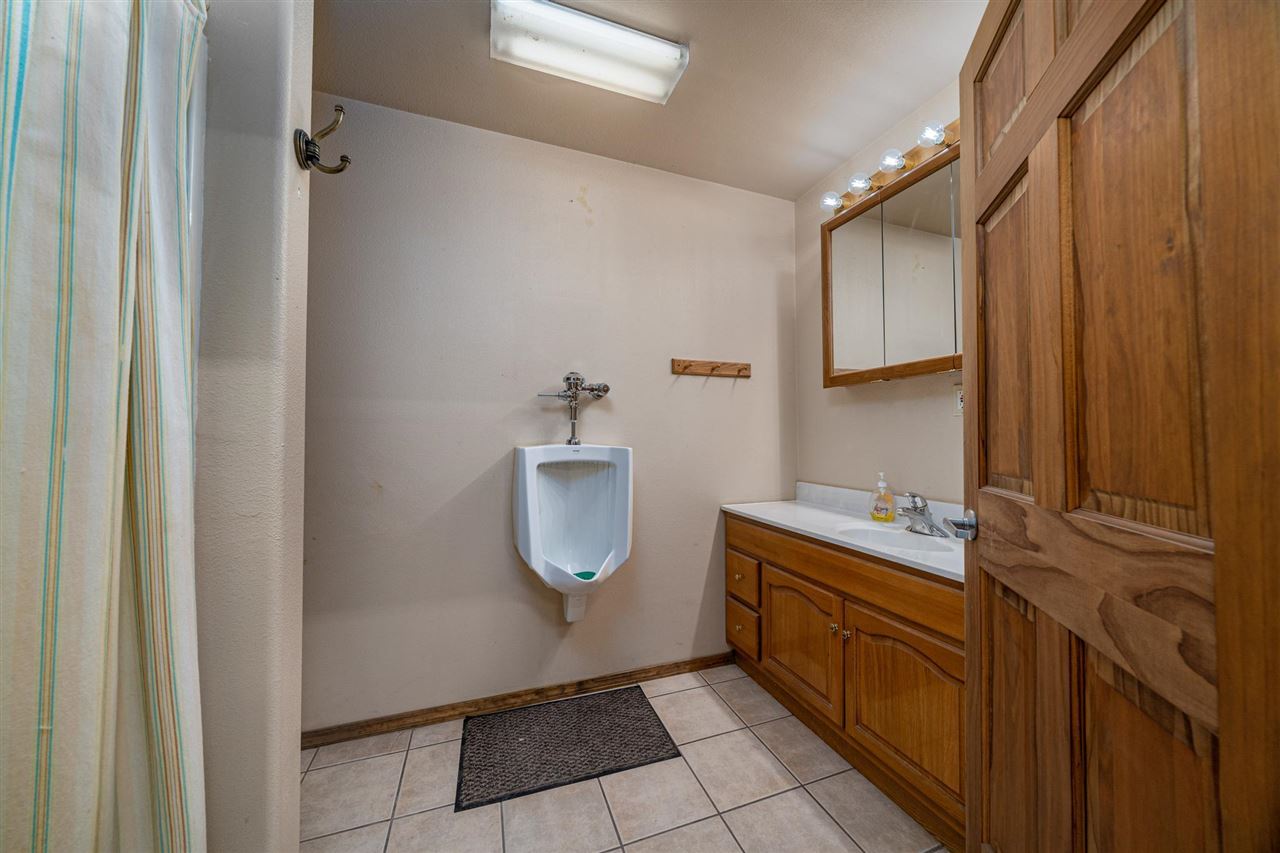 2202 H Road Grand Junction, CO 81505 - Photo 10 of 23 a bathroom with a double vanity sink a mirror and a toilet