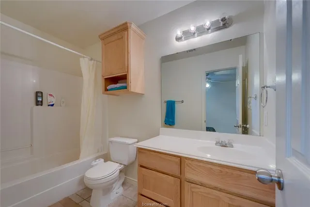 a bathroom with a sink toilet a mirror and shower