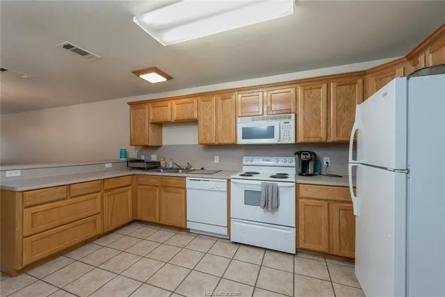 a kitchen with a stove top oven sink and cabinets