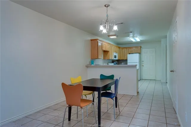a view of a dining room with furniture and chandelier