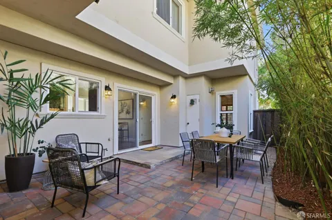 a view of a patio with table and chairs and potted plants