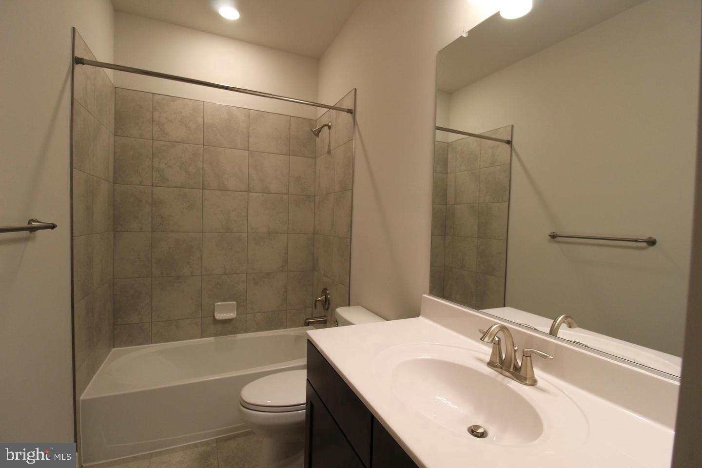22466 Foundation Drive Ashburn, VA 20148 - Photo 18 of 21 a bathroom with a sink a toilet and shower
