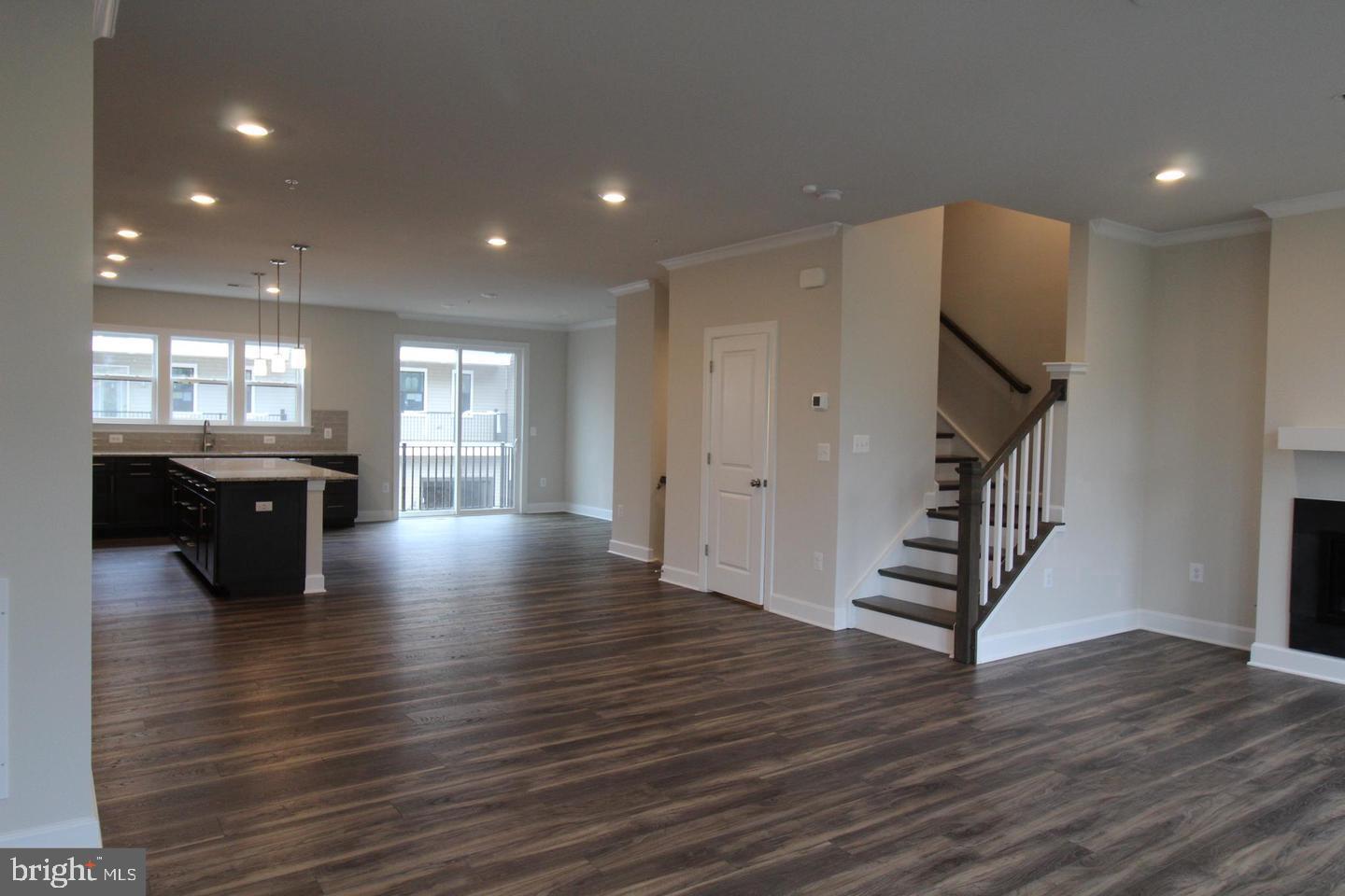 22466 Foundation Drive Ashburn, VA 20148 - Photo 5 of 21 a view of an empty room with wooden floor and windows