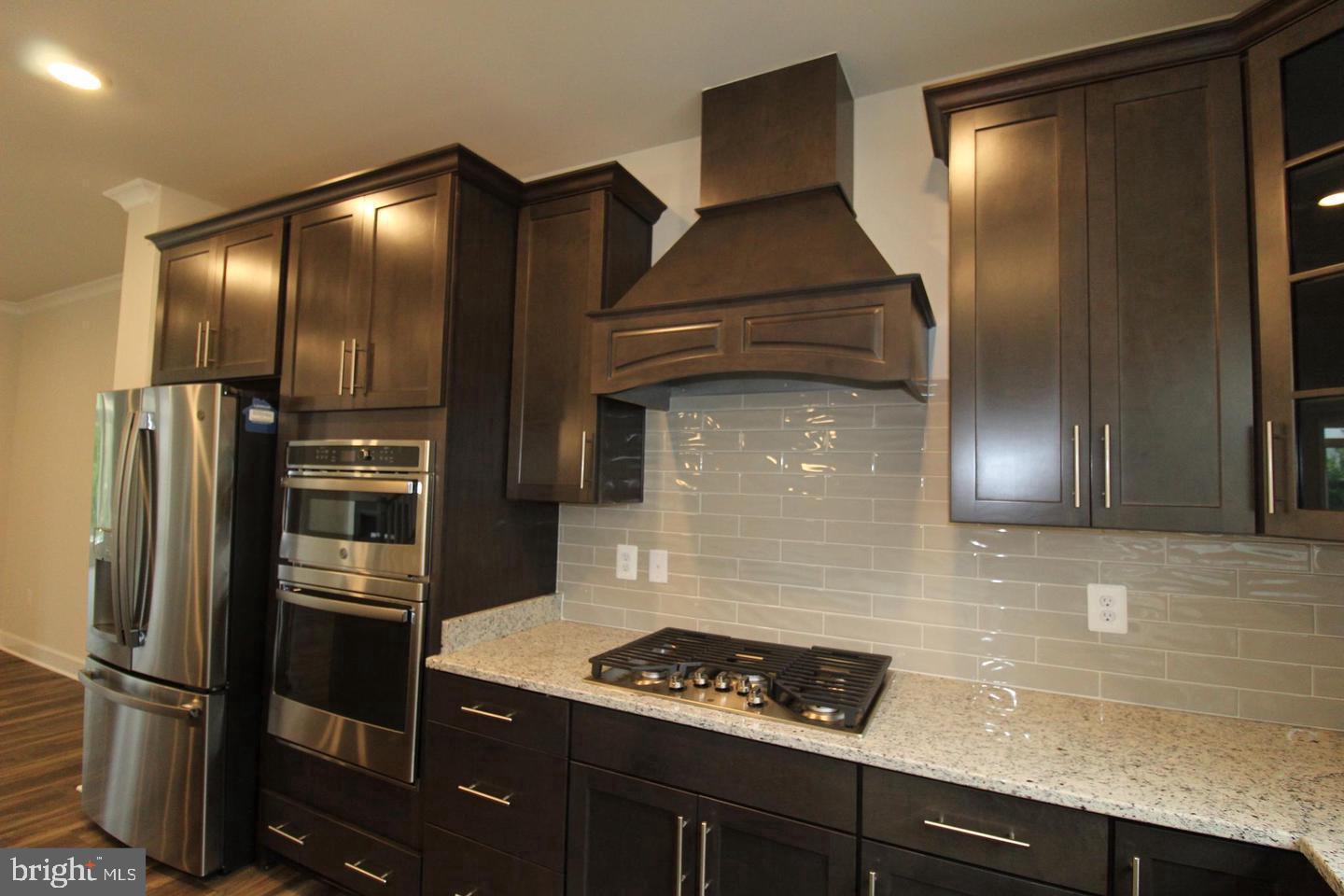 22466 Foundation Drive Ashburn, VA 20148 - Photo 7 of 21 a kitchen with stainless steel appliances granite countertop a refrigerator and a sink