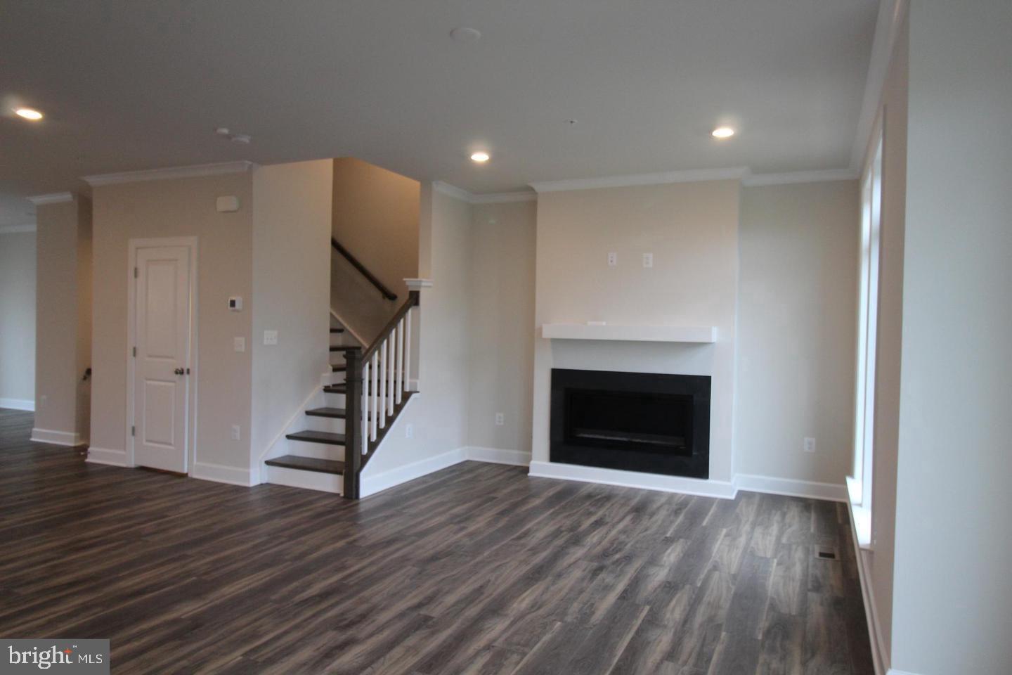 22466 Foundation Drive Ashburn, VA 20148 - Photo 8 of 21 a view of an empty room with wooden floor fireplace and a window