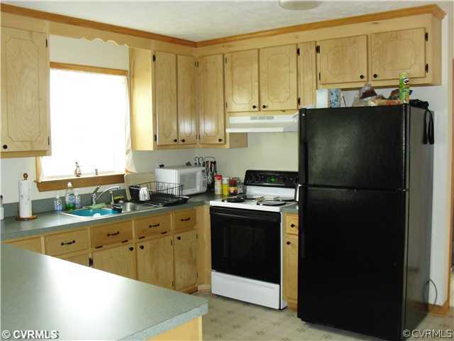 1901 Coxtown Road Crozier, VA 23039 - Photo 5 of 8 a kitchen with stainless steel appliances a refrigerator sink and cabinets