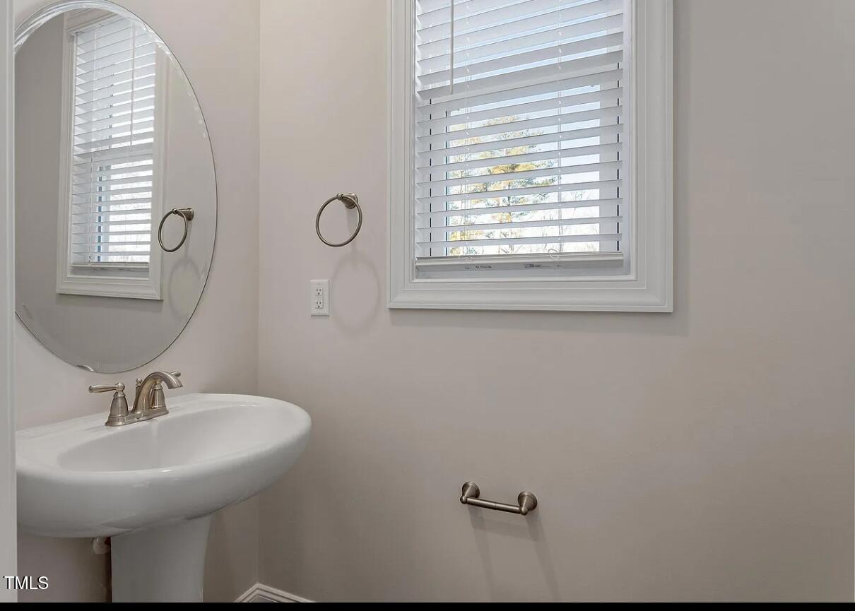 6914 Woodland Stream Place Raleigh, NC 27616 - Photo 3 of 12 a bathroom with a sink and a mirror