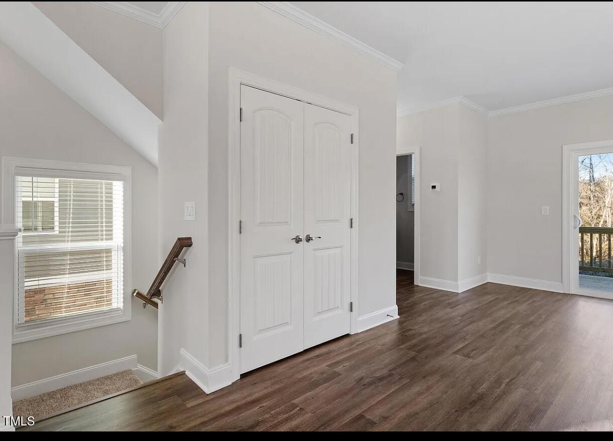 6914 Woodland Stream Place Raleigh, NC 27616 - Photo 4 of 12 a view of empty room with wooden floor and fan