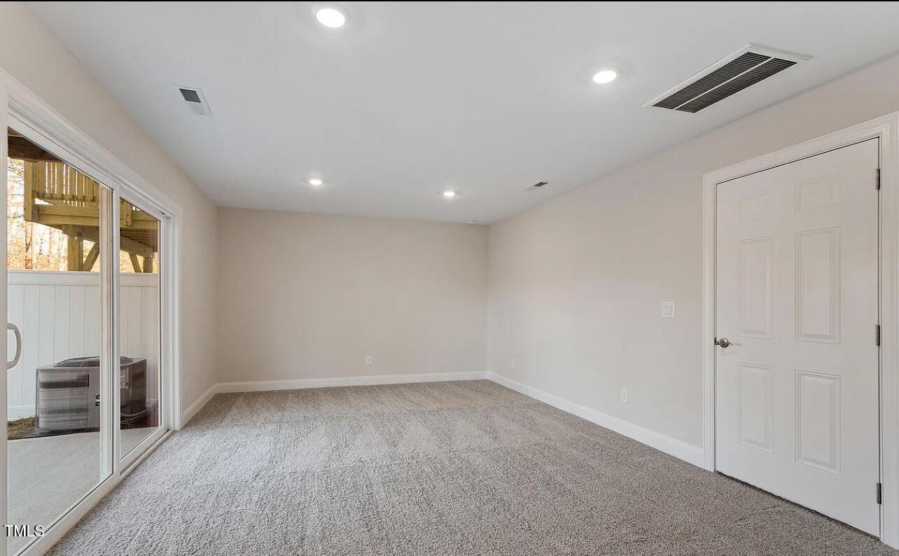 6914 Woodland Stream Place Raleigh, NC 27616 - Photo 5 of 12 wooden floor in an empty room with a window