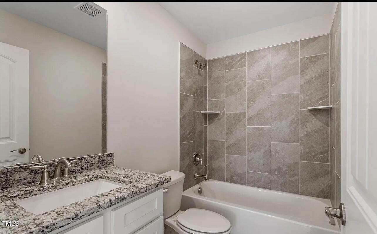 6914 Woodland Stream Place Raleigh, NC 27616 - Photo 7 of 12 a bathroom with a granite countertop sink toilet and shower