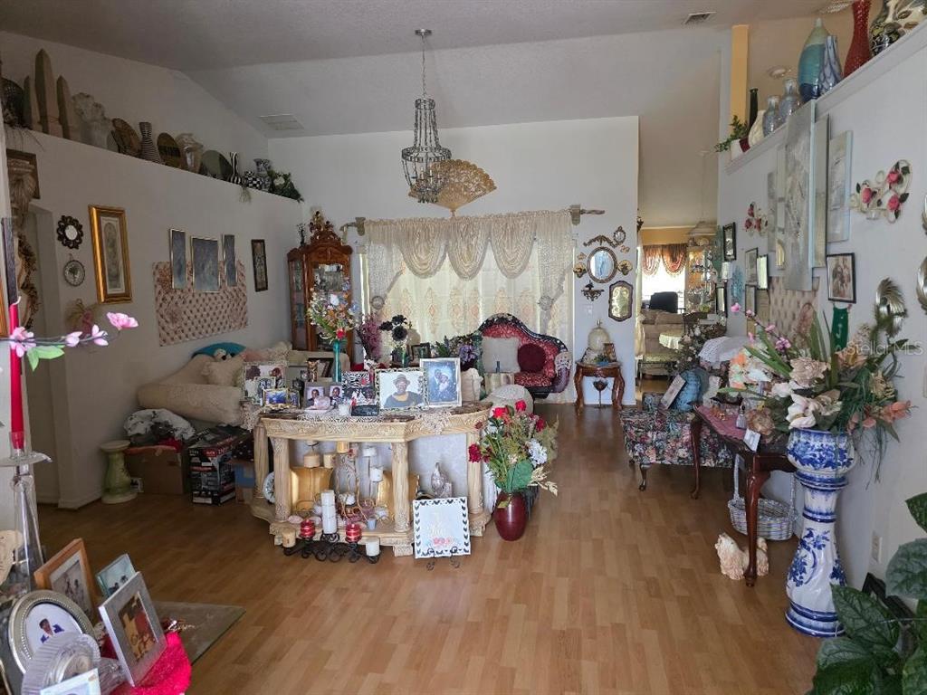 4671 Southwest 100th Lane Ocala, FL 34476 - Photo 4 of 8 a kitchen with lots of wooden furniture and potted plants