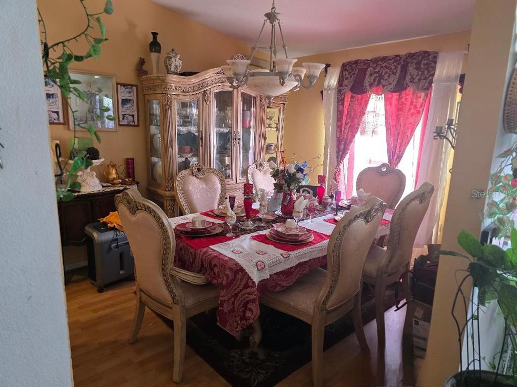 4671 Southwest 100th Lane Ocala, FL 34476 - Photo 5 of 8 a view of a dining room with furniture and window