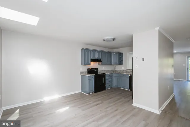 a kitchen with a refrigerator sink and stove top oven