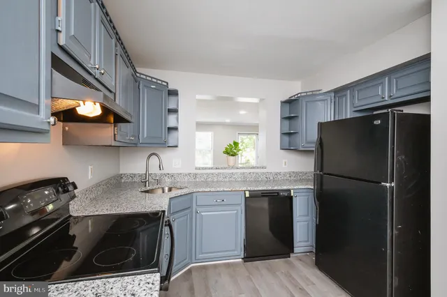 a kitchen with a sink stove and refrigerator