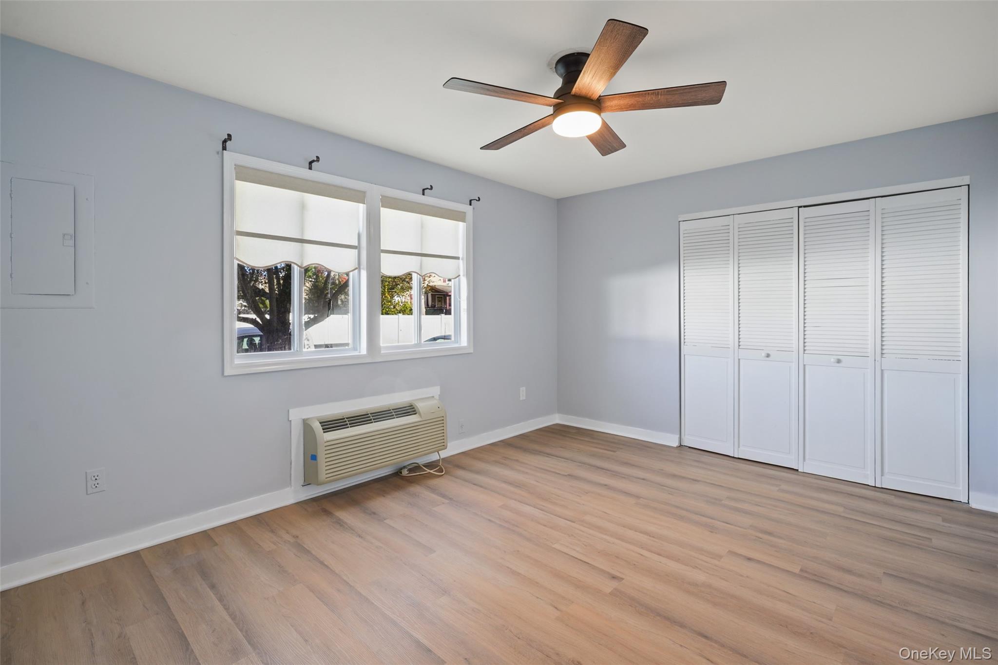 9 C Kings Court, Unit C Mohegan Lake, NY 10547 - Photo 13 of 31 wooden floor in an empty room with a window
