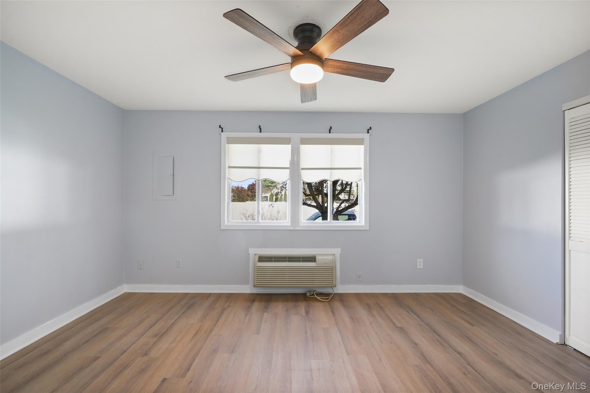 9 C Kings Court, Unit C Mohegan Lake, NY 10547 - Photo 14 of 31 an empty room with wooden floor and windows