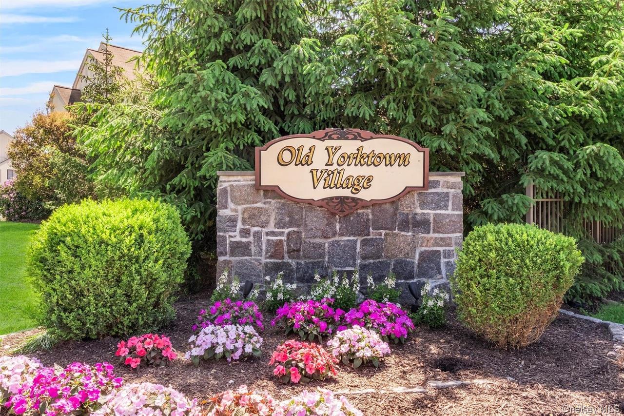 9 C Kings Court, Unit C Mohegan Lake, NY 10547 - Photo 2 of 31 a sign that is sitting in front of flowers