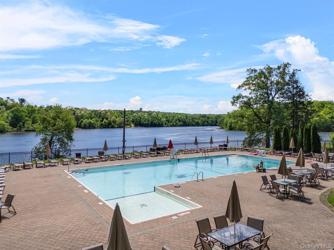 9 C Kings Court, Unit C Mohegan Lake, NY 10547 - Photo 23 of 31 a view of a swimming pool and lounge chairs in patio