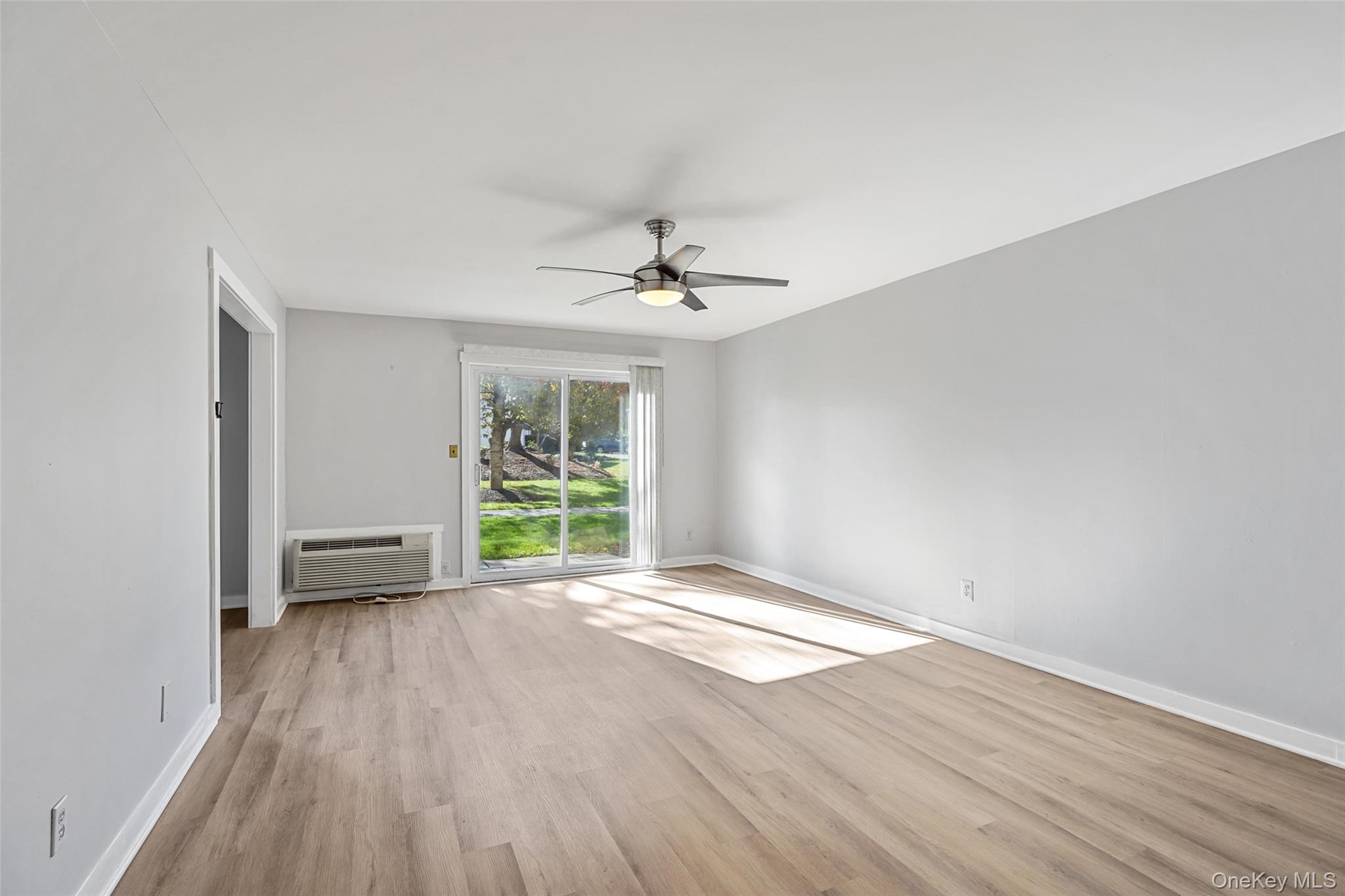 9 C Kings Court, Unit C Mohegan Lake, NY 10547 - Photo 6 of 31 wooden floor in an empty room with a window