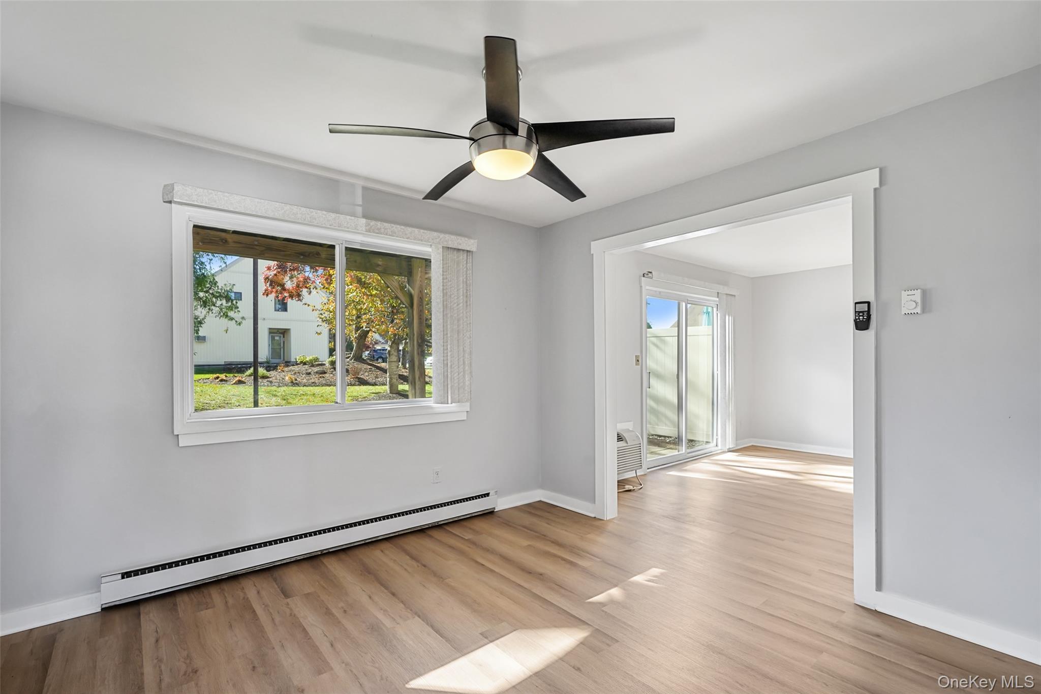 9 C Kings Court, Unit C Mohegan Lake, NY 10547 - Photo 7 of 31 wooden floor in an empty room with a window